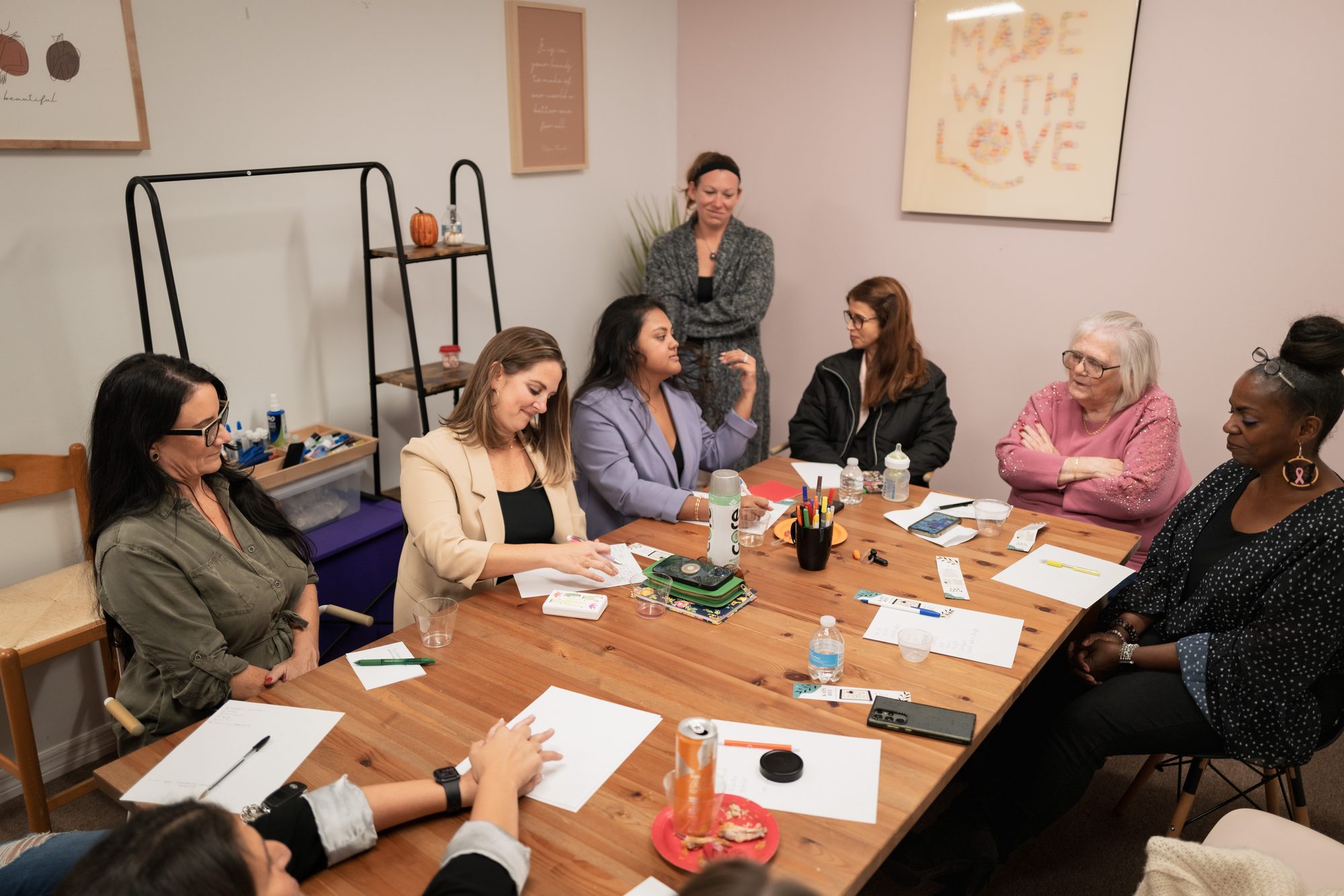 Women gathered around a table at an EmpowHERment workshop
